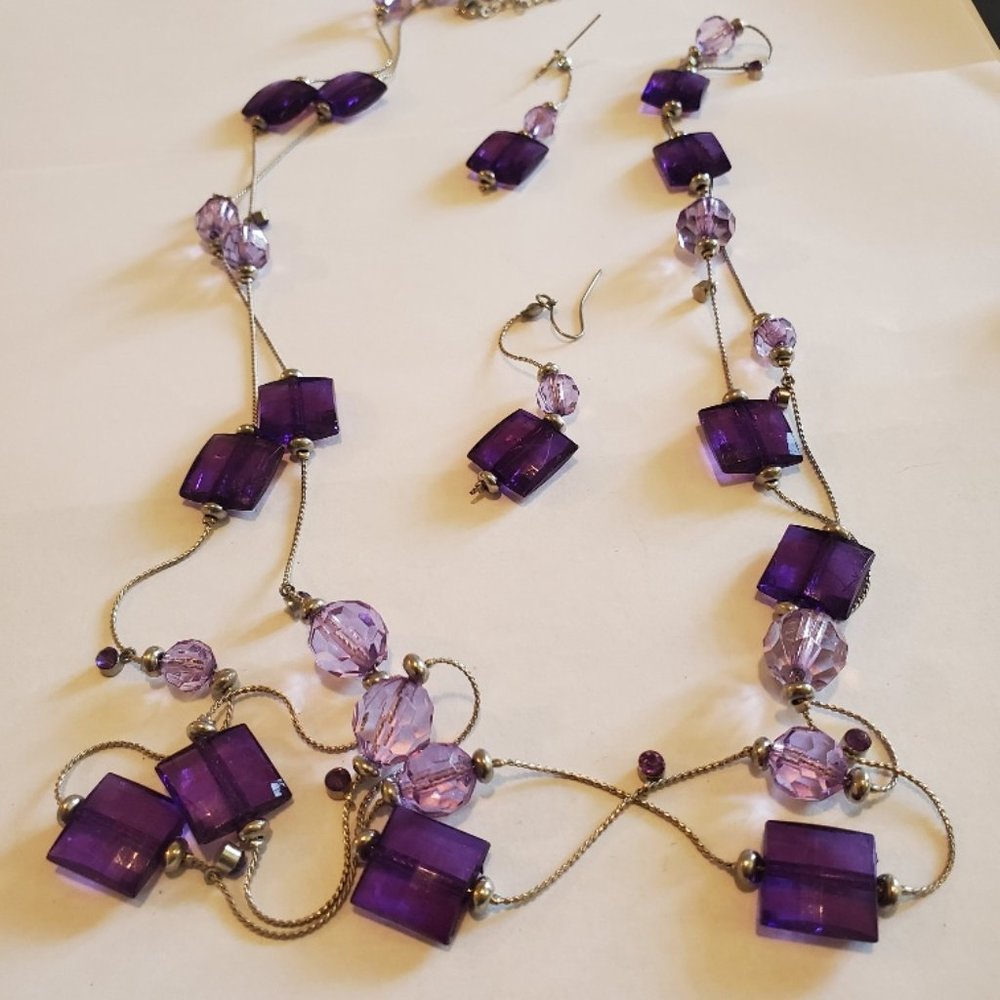 purple necklace and ear rings